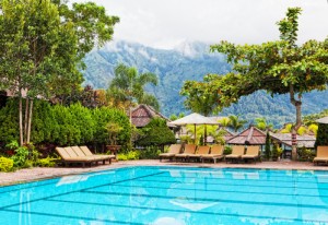 Chaise lounges at pool in hotel in tropics